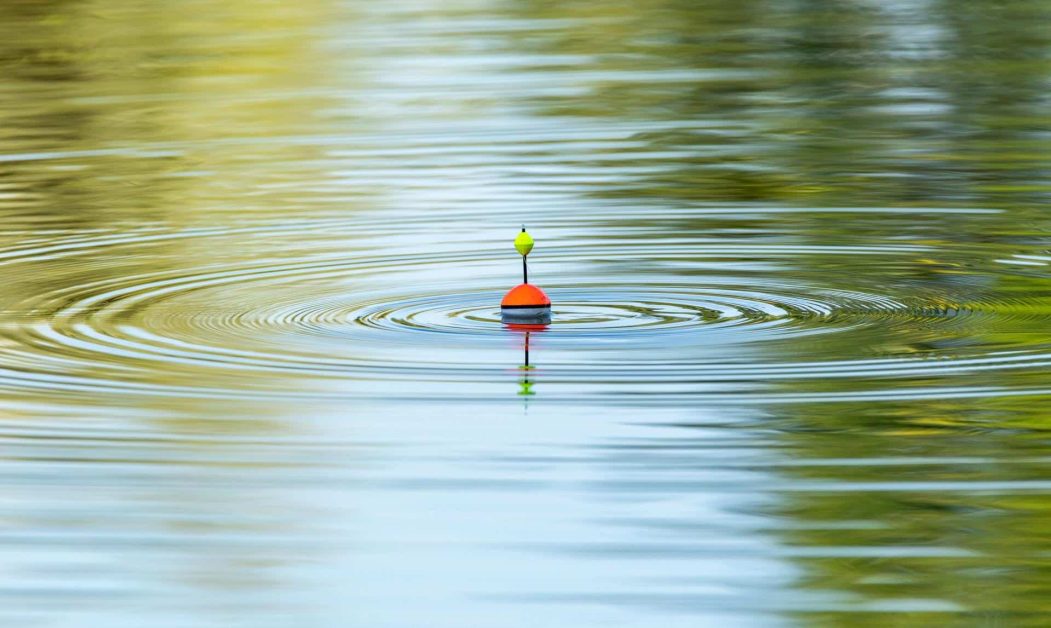 float fishing on the water waiting for a fish to bite