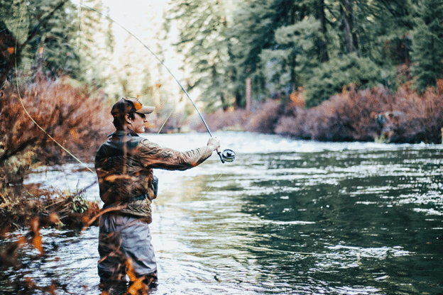 Fly fishing in river in the summer