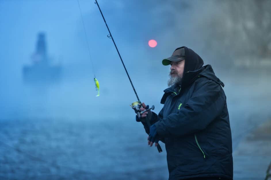 Fisherman fishing in the winter cold