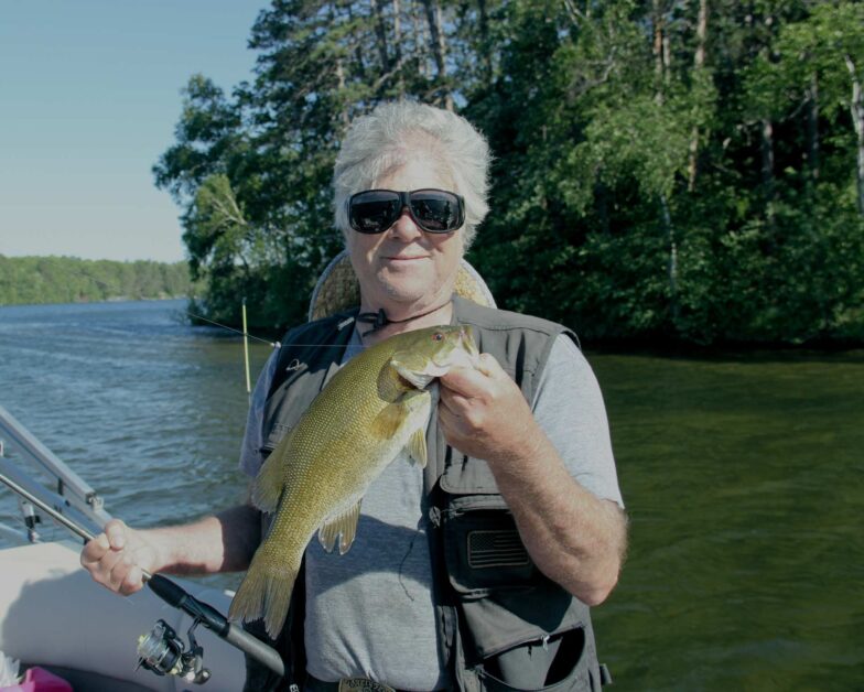 fisherman holding smallmouth bass