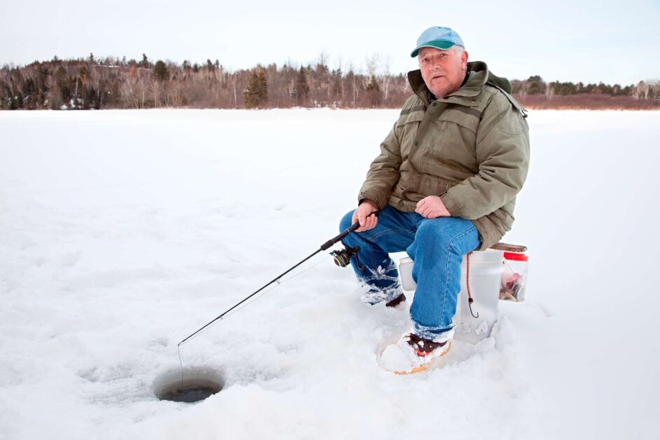 fisherman ice fishing on lake of the woods