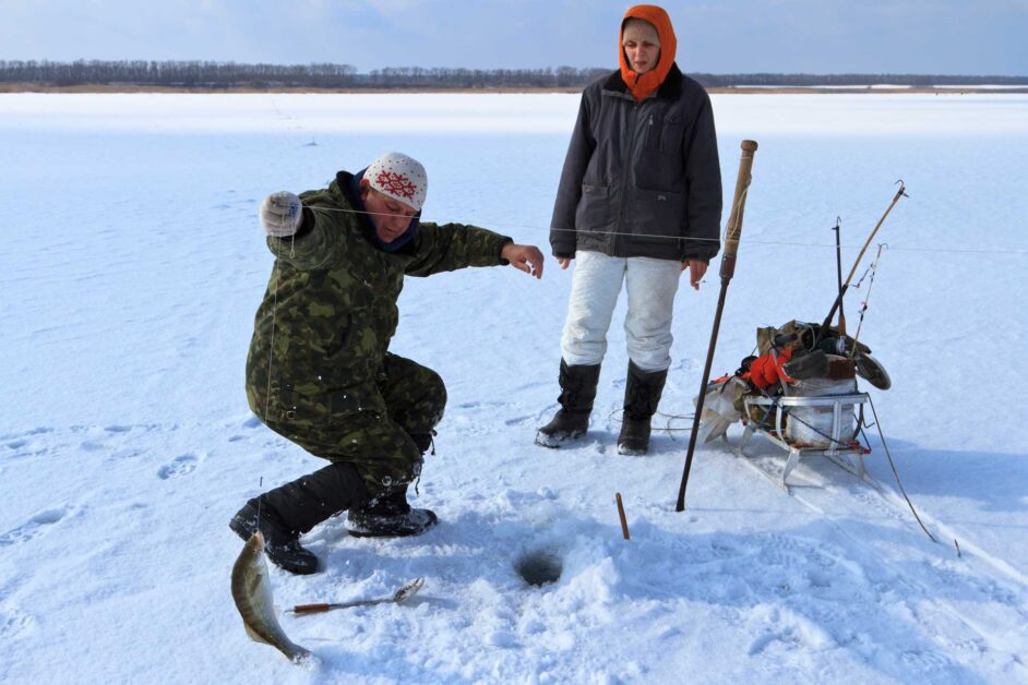 Catching fishing while Maine ice fishing