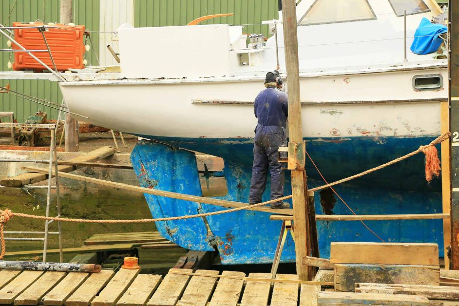 Boat maintenance expenses a man fixing his boat