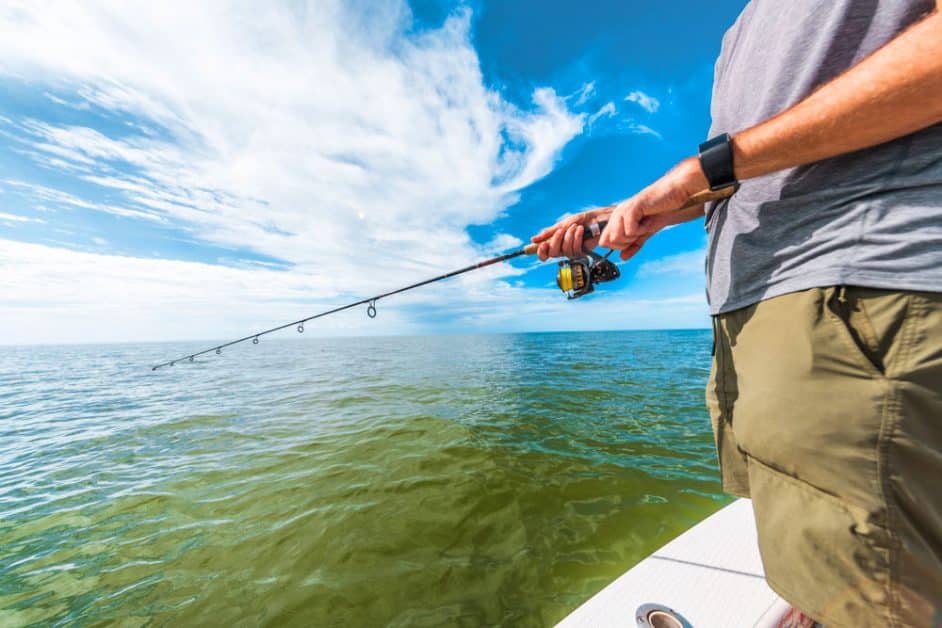 Man fishing off the side of his boat