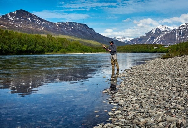 Fishing in a river wearing waterproof boots