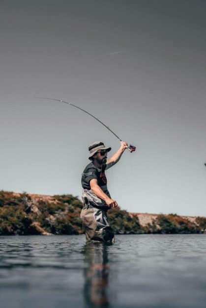 fisherman protecting his feet with waterproof boots